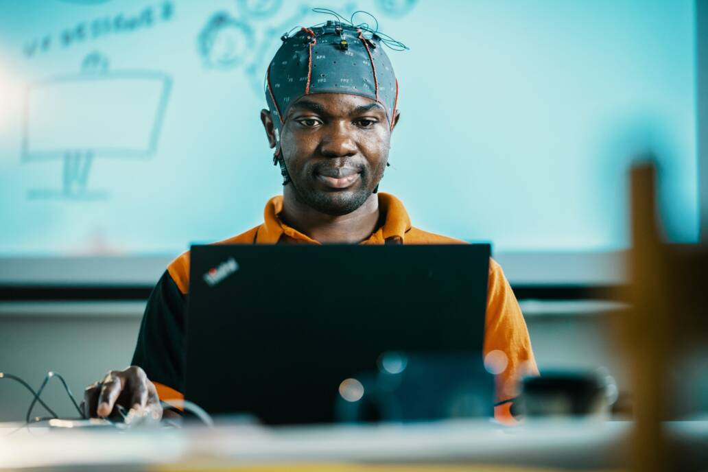 PhD student wearing a hat with wires